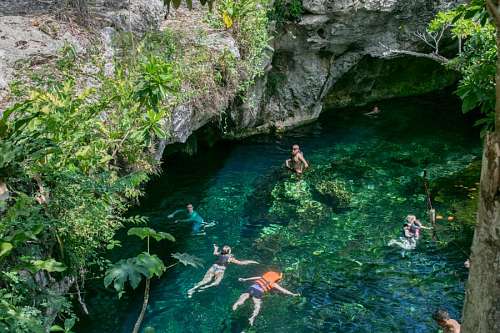People swimming in a cenote in Tulum, Riviera Maya