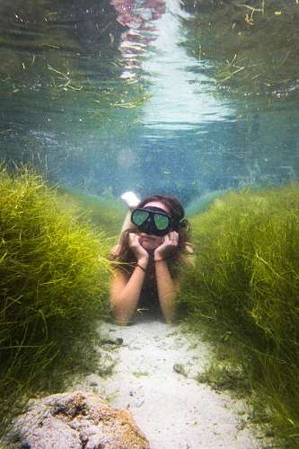 Woman posing while snorkeling in a reef