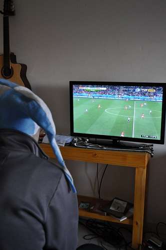 A fan watching Argentine soccer game on tv