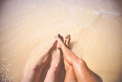 feelings Legs of bride and groom on the beach
