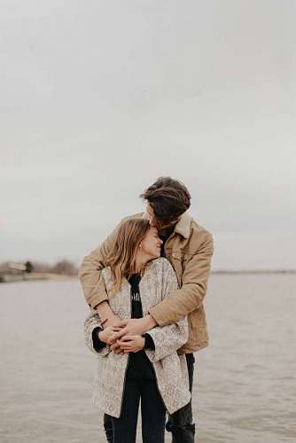 a young couple hugging on the coast