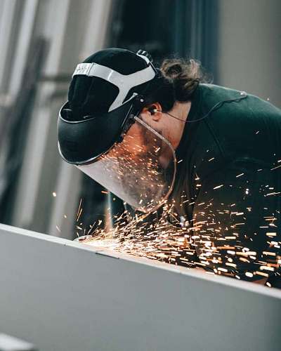 Close-up of a workman cutting a metal plate