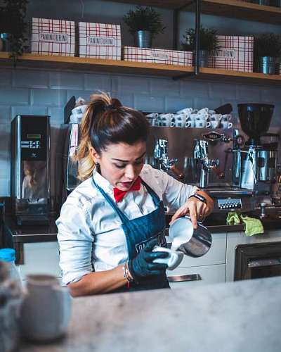 A worker in an espresso bar preparing coffee