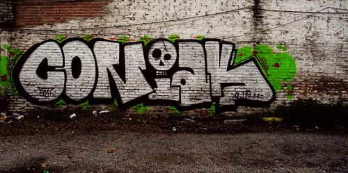 Street graffiti on wall by Coñak