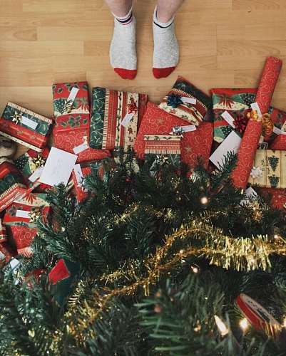 christmastime Boy with stockings waiting for Christmas gifts on the tree