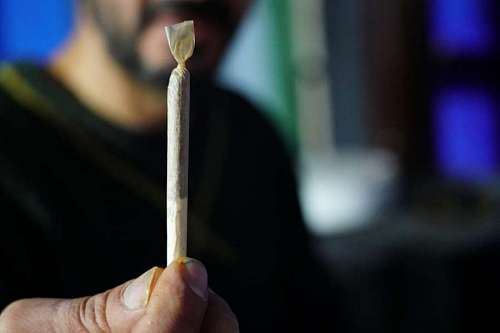joy Man Holding a Marijuana Cigarette