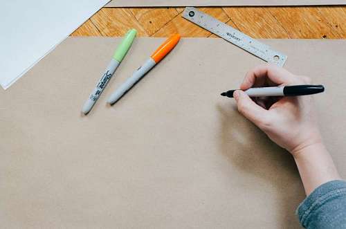person drawing with colored markers