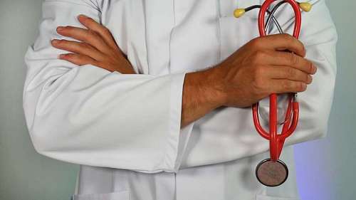 close-up of doctor with stethoscope in hand