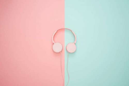 Pink headphones on pastel background
