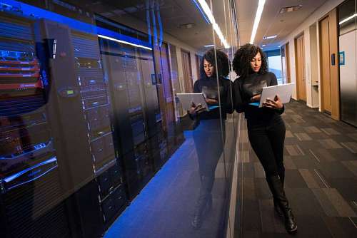 main Engineer woman with laptop performing maintenance on servers
