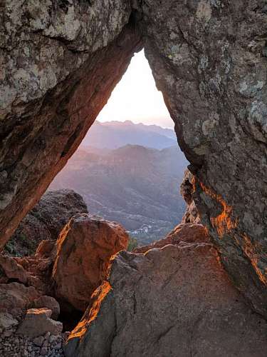 sunbeam Sunbeams at sunrise on a rocky mountain shaped like a triangle
