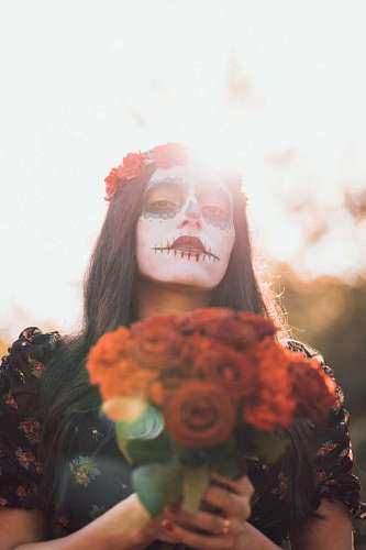 Woman with face painted on the day of the dead