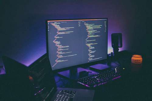 computer with progamming  codes with a violet background