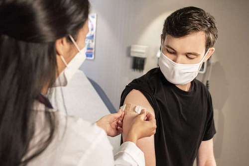 arm-around A man after being vaccinated