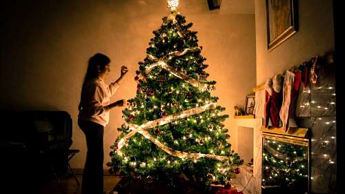 christmastime Little girl decorating Christmas tree