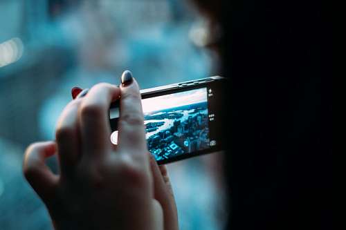 Woman taking photos with cellphone
