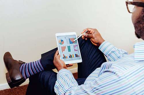 Businessman analyzing graphs on a tablet
