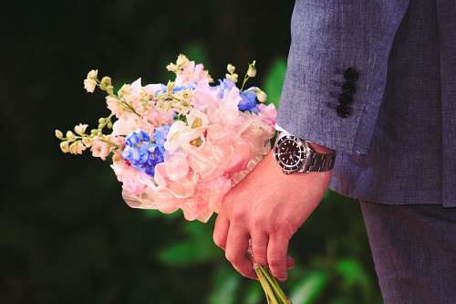 Groom on his anniversary with floral arrangement