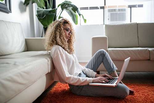 beautiful woman uses her laptop in the comfort of her living room