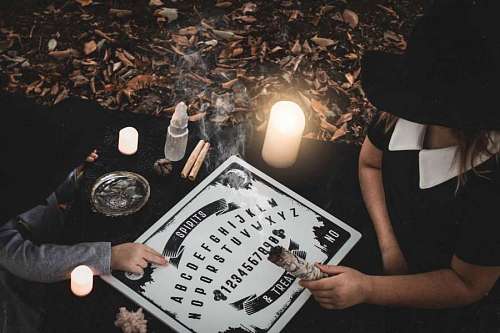 demon-fictional-character People playing ouija board on halloween