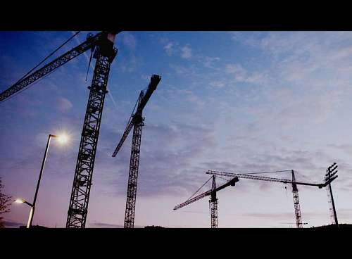 crane-machinery Mechanical cranes working at sunset