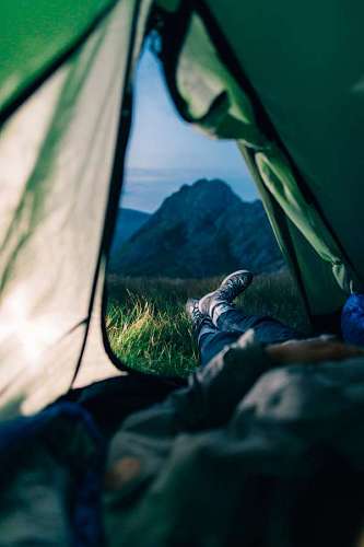 backpacking Man in a tent looking at the mountain landscape