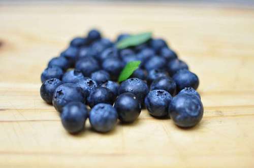 blueberries Selective focus of blueberries over wood background