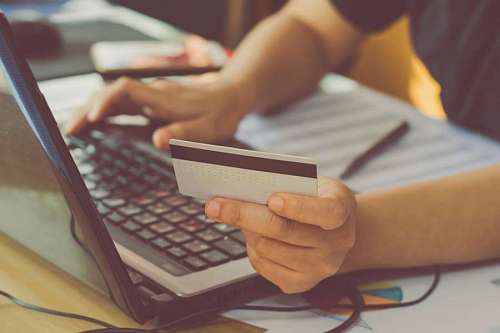 paying-in-store Man using laptop making online payment online with credit card