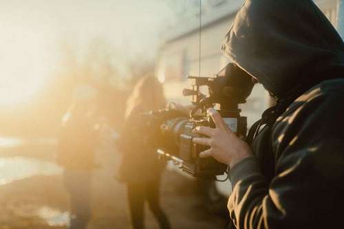 closeup of a cameraman shooting a couple