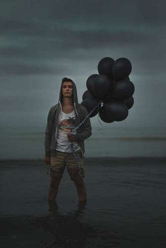 Man with black balloons