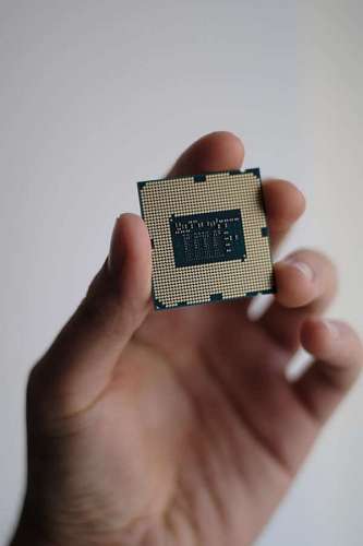 main Hand holding a computer microchip