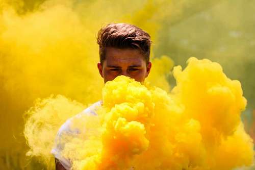 christian-worship Portrait of man between yellow smoke bomb