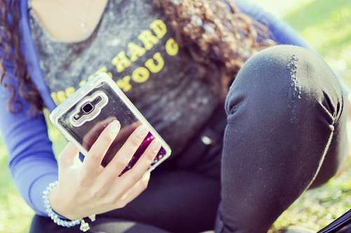 rear-view Woman with smartphone 