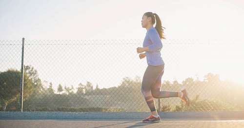 runner woman running while in the sunshine