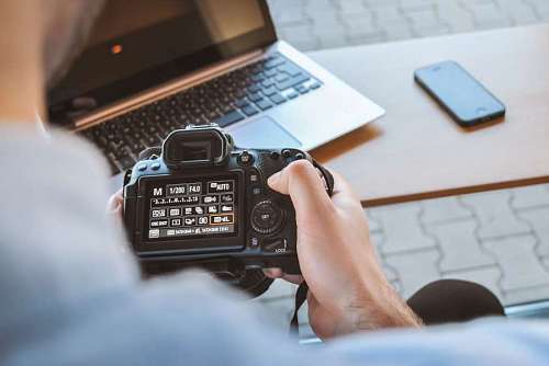 close-up of a man setting up his photo camera