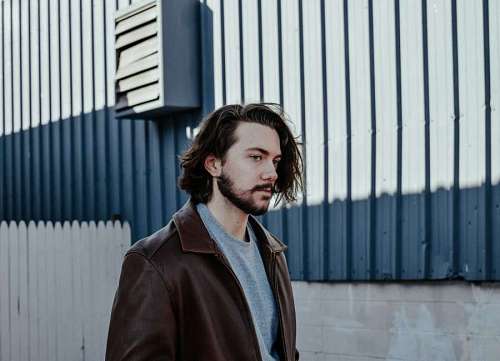 Elegant young man walking in the city