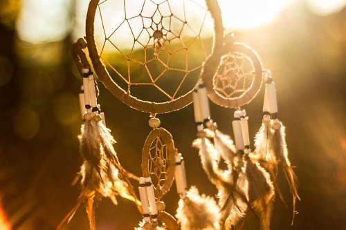 indigenous closeup of a dreamcatcher with sun glare in the background