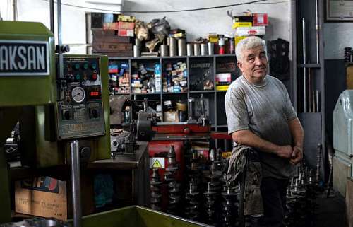 main Mechanic posing in a mechanical workshop