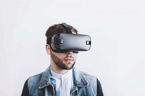 young man using VR with a white studio background