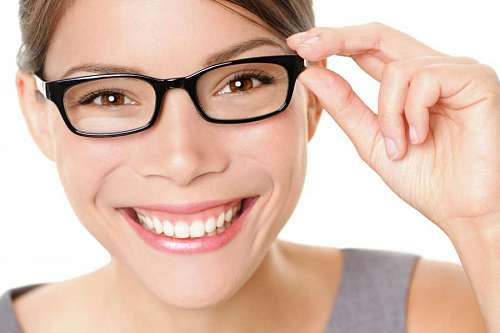 brunette Young woman with glasses looking at the camera