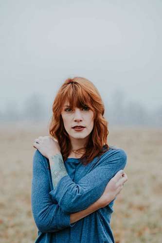 Young redhead woman looking at camera
