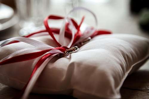 Wedding bands with white and red ribbons