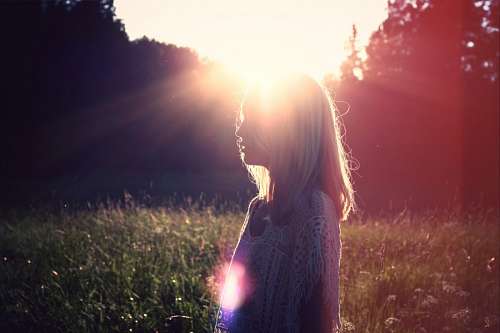 Woman in the forest at sunset