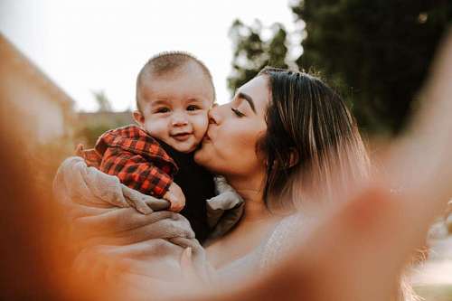 Mother kissing her son on the cheek
