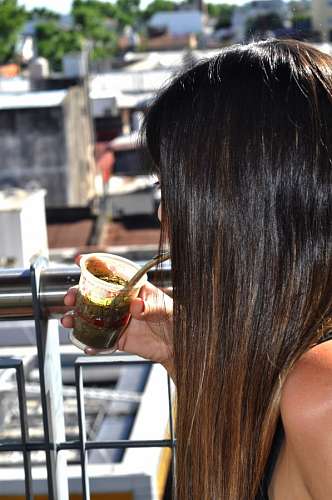 killing Woman drinking mate on terrace