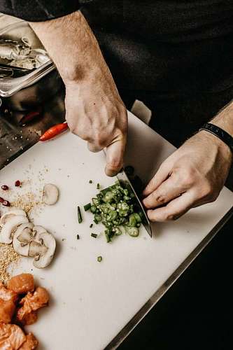 chef cutting pieces of vegetables 