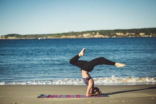stretch-mark Woman doing yoga exersices beach