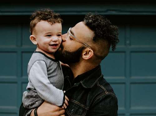 Father kissing his son