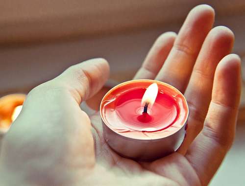 sustainability Hand holding a light candle