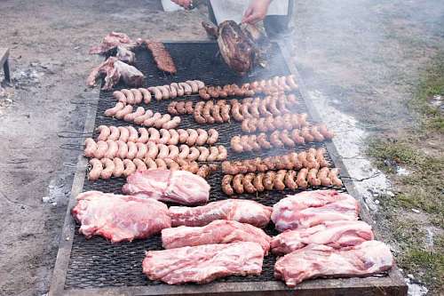 A typical Argentine barbecue man with pork sausages and pork